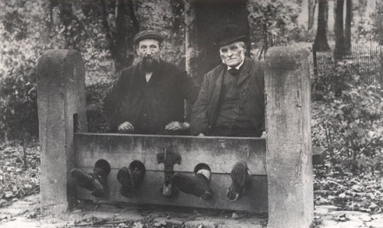 Men in Bramhall stocks, Bramhall, England, 1900, unknown photographer.